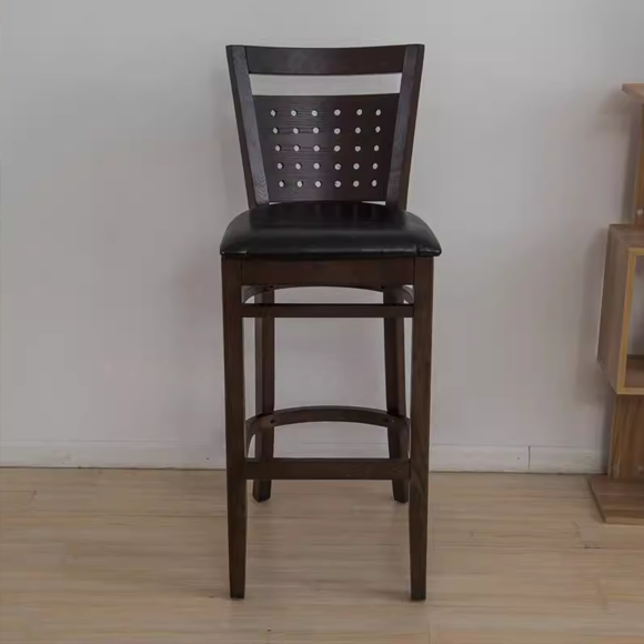 Set of 2 vintage wooden bar stools with black leather cushions and backrests, featuring perforated back designs, ideal for modern bar settings.