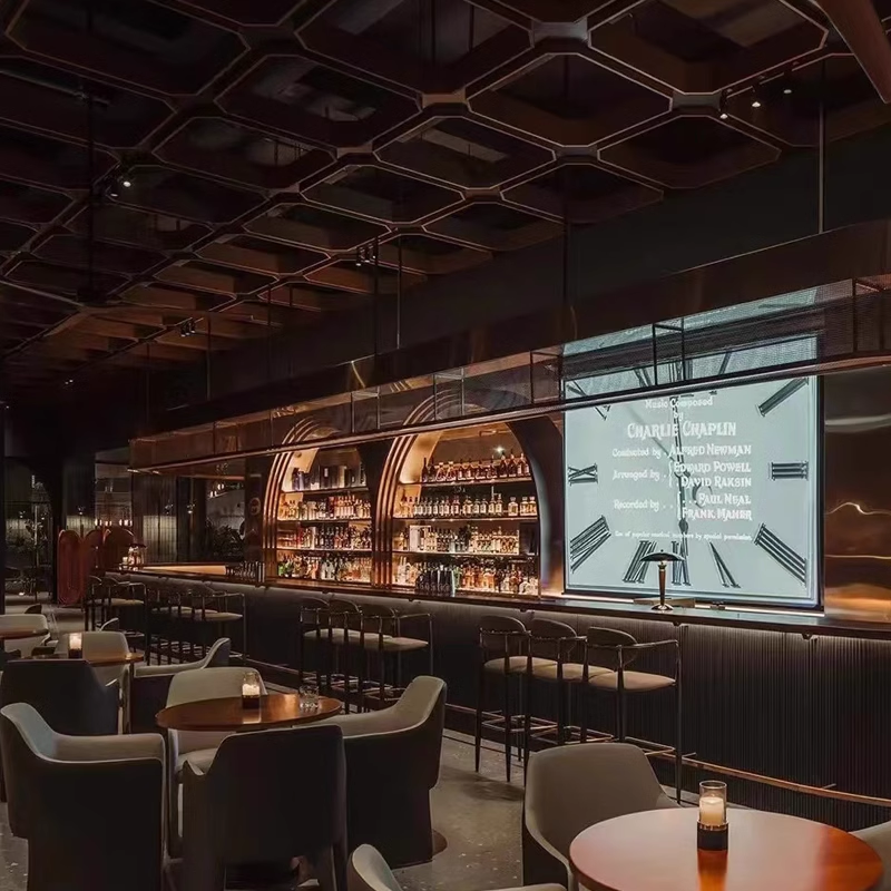 A modern bar with black and gold accented bar stools in a chic, stylish lounge setting.