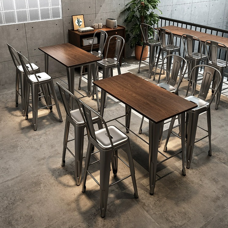 Industrial-style cafe setting with metal chairs and wooden tables in a cozy interior.