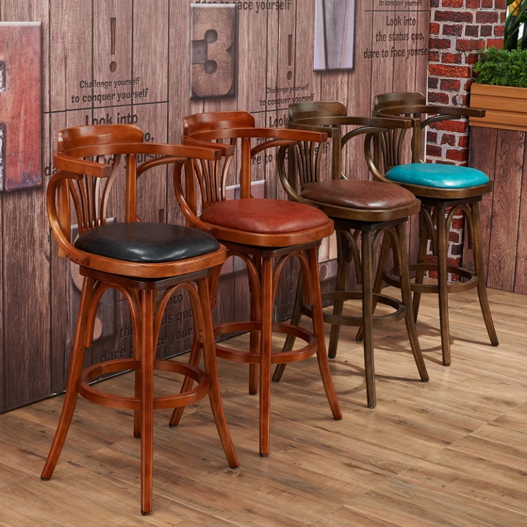 This wooden bar stool features a curved backrest for added support, a sleek leather seat for comfort, and a sturdy frame designed for long-lasting use in commercial and home settings