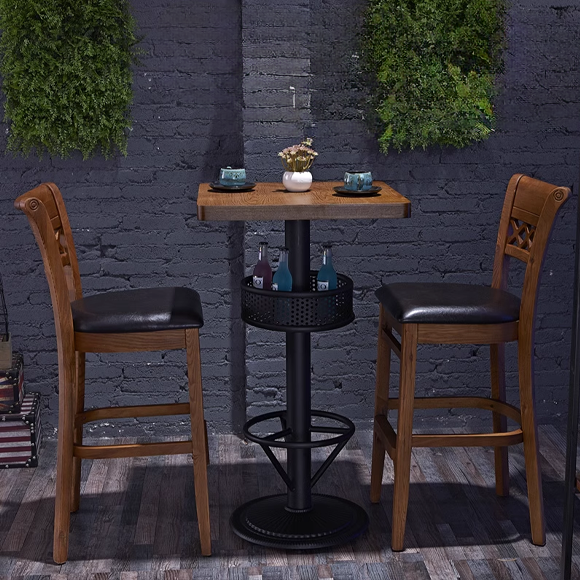 Wooden bar stool with cross-back support and black cushioned seat.