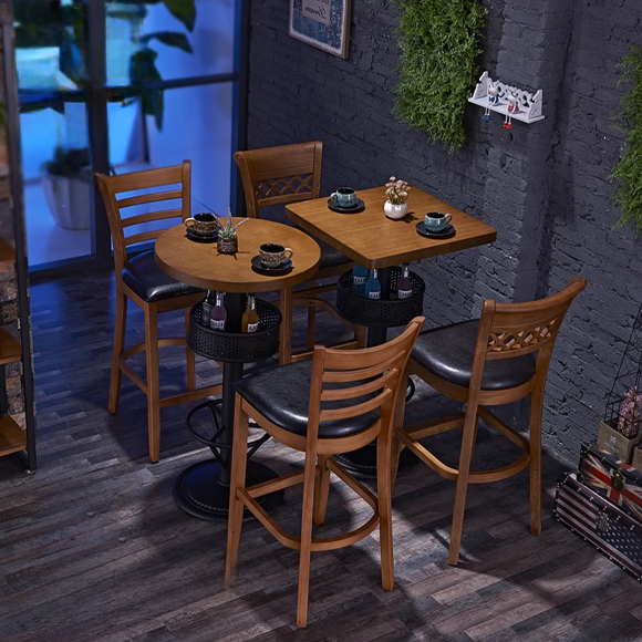 Modern bar height table with matching wooden bar stools and a cozy indoor setting.