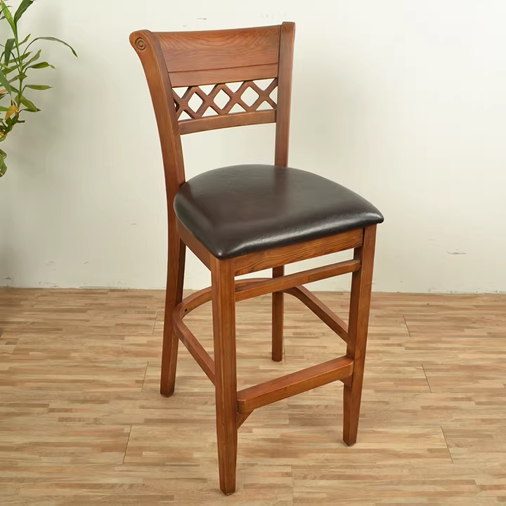 Wooden bar stool with tan cushioned seat and wooden frame.