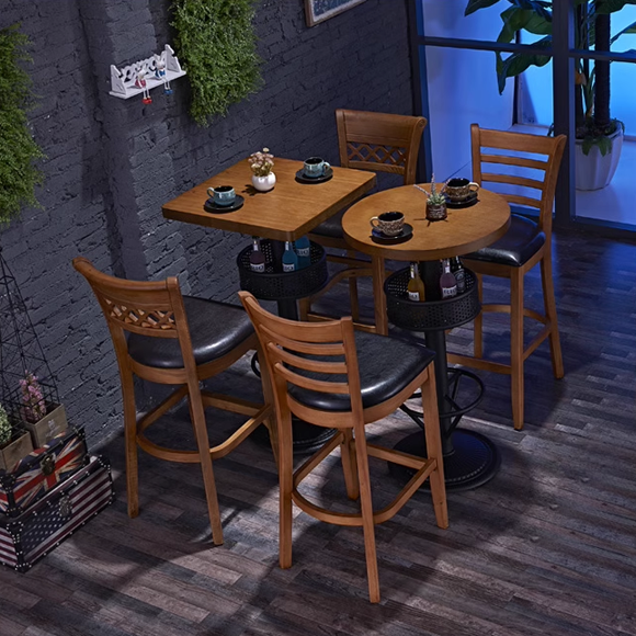 Modern bar height table with matching wooden bar stools and a cozy indoor setting.