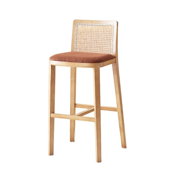 Natural wood bar stool featuring a rattan backrest and a fabric cushioned seat, blending rustic charm with modern elegance.