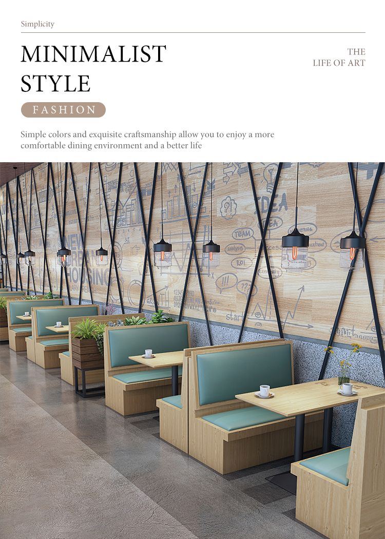 Elegant dining area with wooden booth seating featuring green upholstered cushions, modern pendant lights, and a stylish wall with creative illustrations.