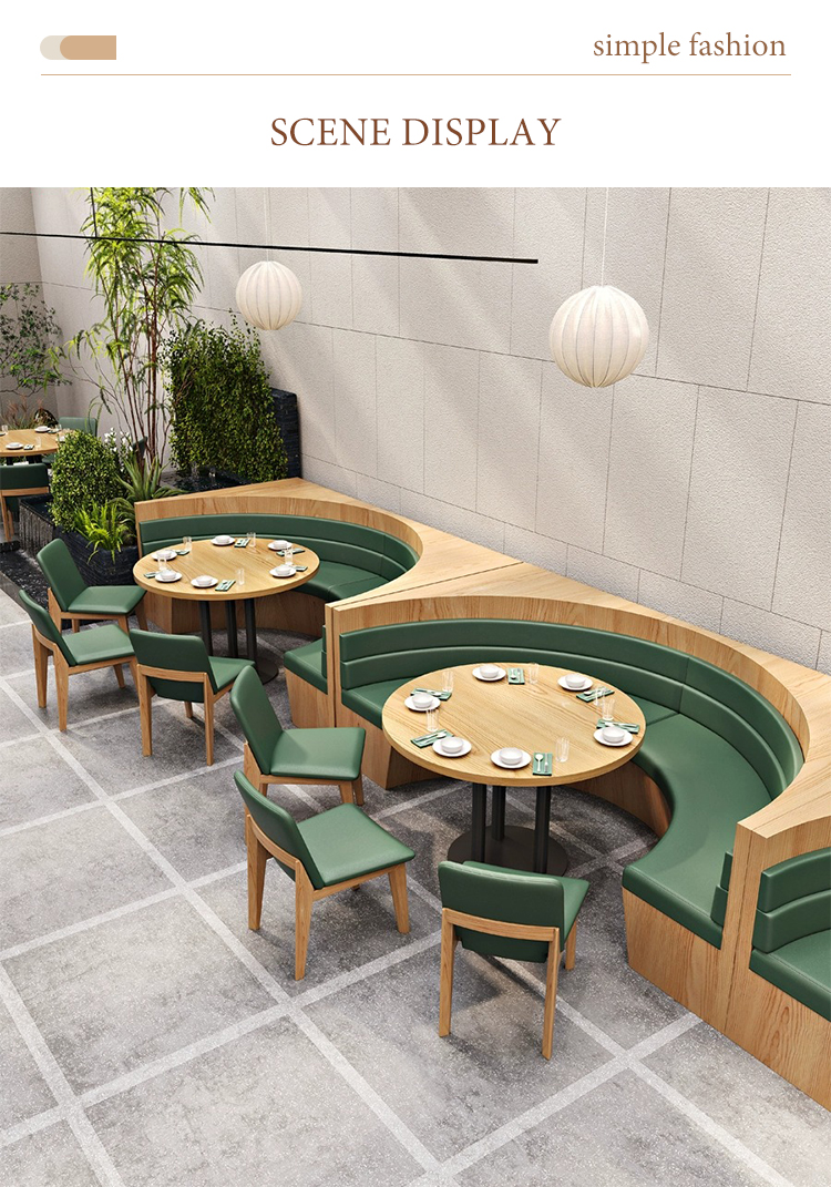 Curved green restaurant booths with wooden frames, round dining tables, and matching green chairs.