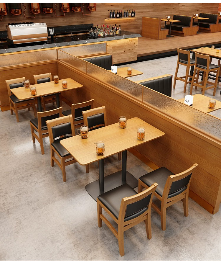 Restaurant layout with wooden tables, black cushioned chairs, and booth seating, creating a warm and stylish dining environment