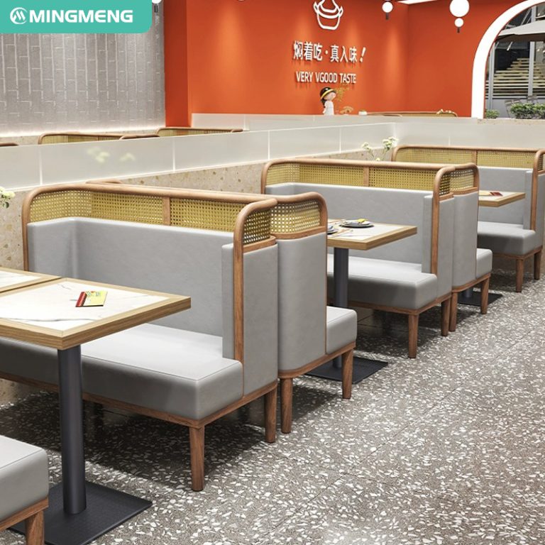 Modern rattan booth seating with wooden accents and neutral gray cushions in a contemporary restaurant setting.