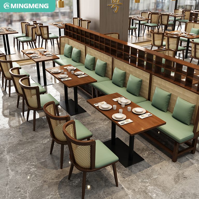 Restaurant layout with long bench seating, green cushions, woven backrest chairs, and wooden tables for a stylish dining experience