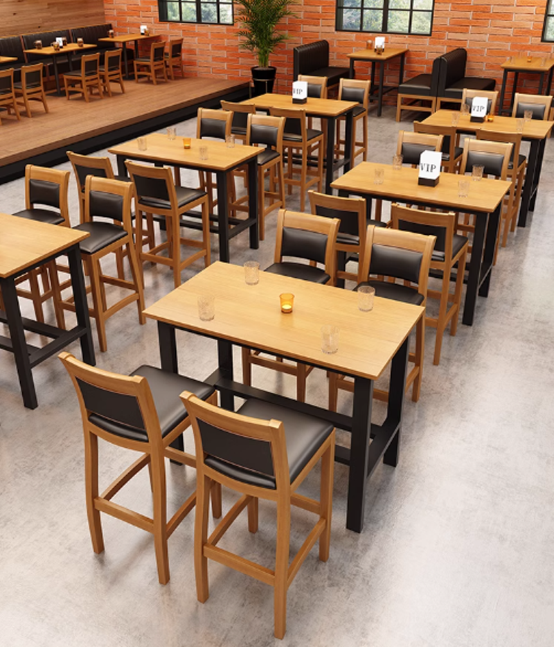 Wooden dining set with chairs and tables, featuring black and brown seating, beer glasses, and partitions in a casual restaurant setting.