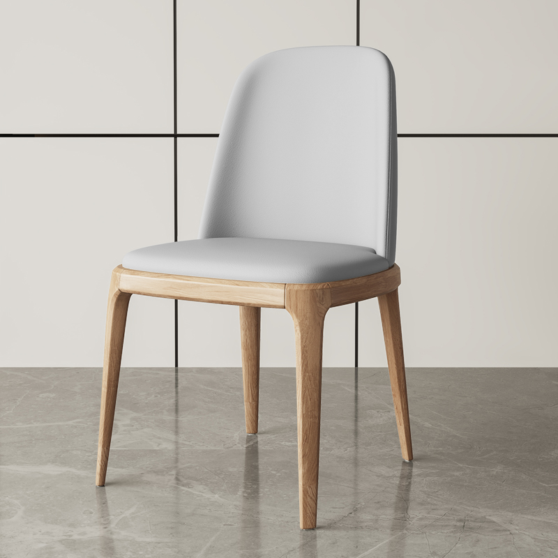 Elegant modern dining chair with white leather upholstery and a natural wood frame, perfect for upscale dining spaces.