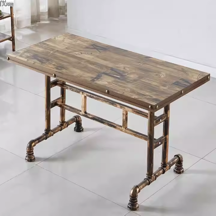 Industrial retro dining table with vintage printed wooden top and pipe legs, featuring a sturdy brass-colored frame.