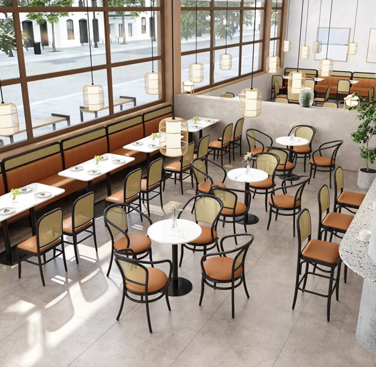 Premium commercial furniture design featuring a spacious dining area with rattan-back chairs, leather seat cushions, and sleek black metal frames, complemented by modern pendant lighting and natural light