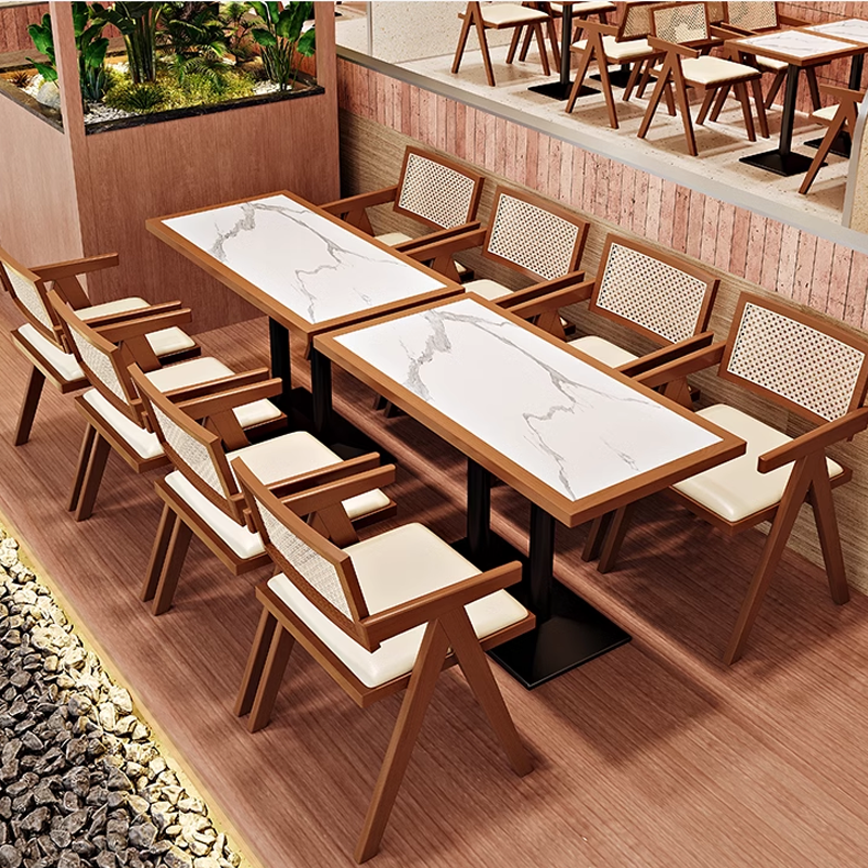 Contemporary dining area with cane-back chairs and marble-topped tables, perfect for modern restaurant interiors.