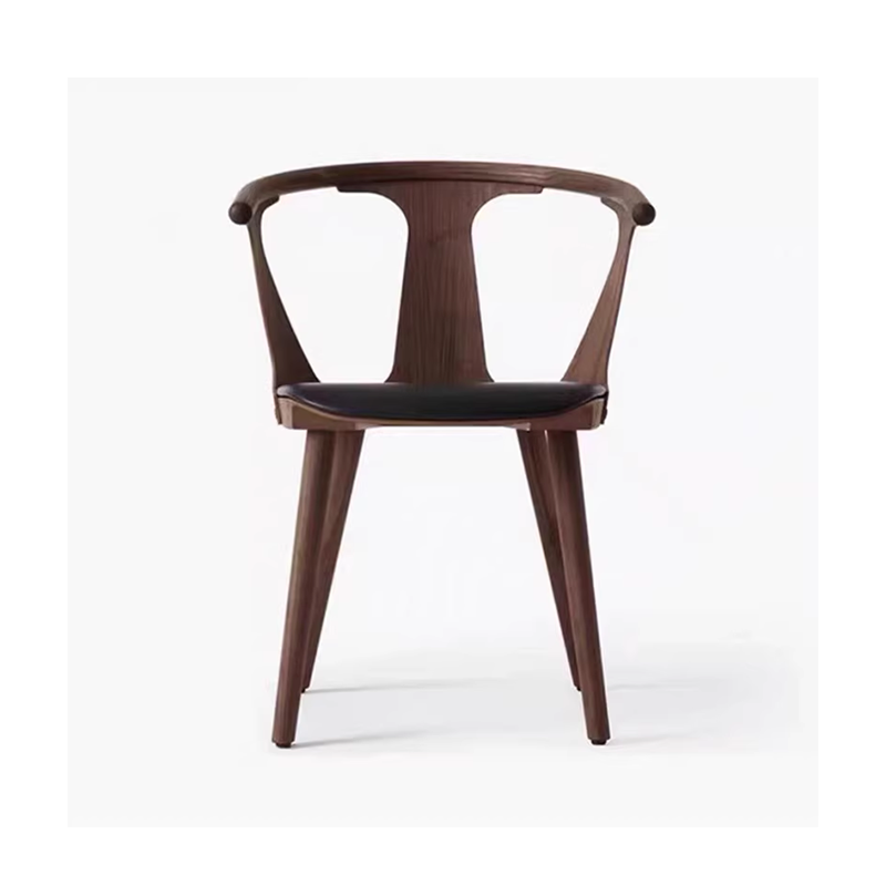 Dark wooden armchair with a black cushioned seat, modern design featuring curved armrests and a bold aesthetic.