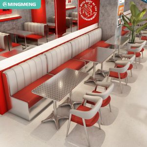 Diner-style seating arrangement featuring red and white upholstered booth, modern metallic chairs, and polished steel tables.