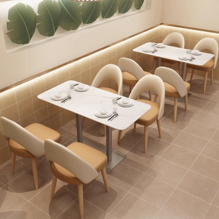 Dual-row dining layout with white marble-top tables and cushioned chairs in a modern style.