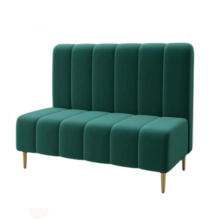 Green velvet upholstered restaurant booth seating with vertical channel tufting and gold-tipped legs.