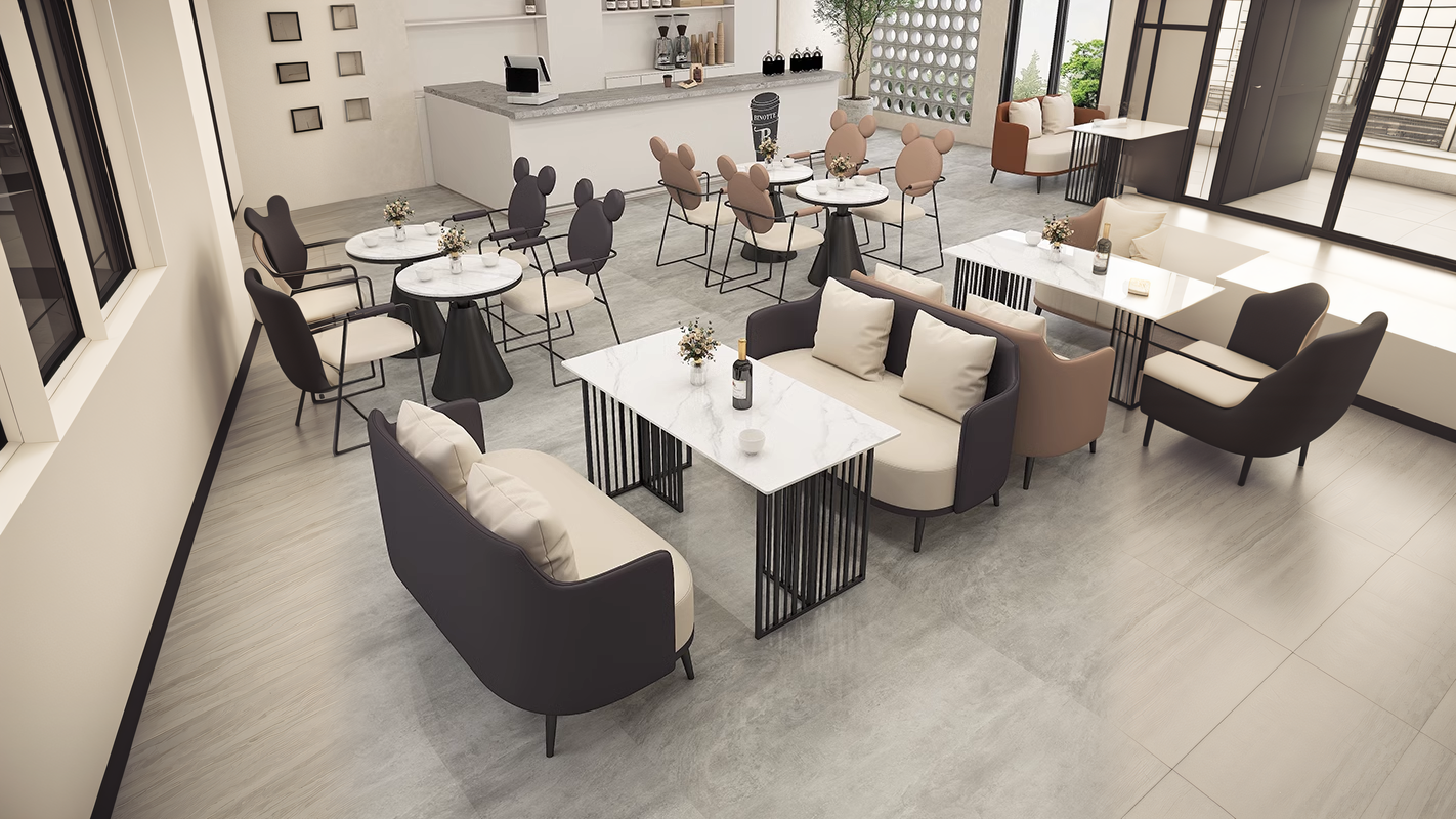 Contemporary cafe seating arrangement featuring minimalist sofas, marble-top tables, and stylish chairs with a bright and airy ambiance.