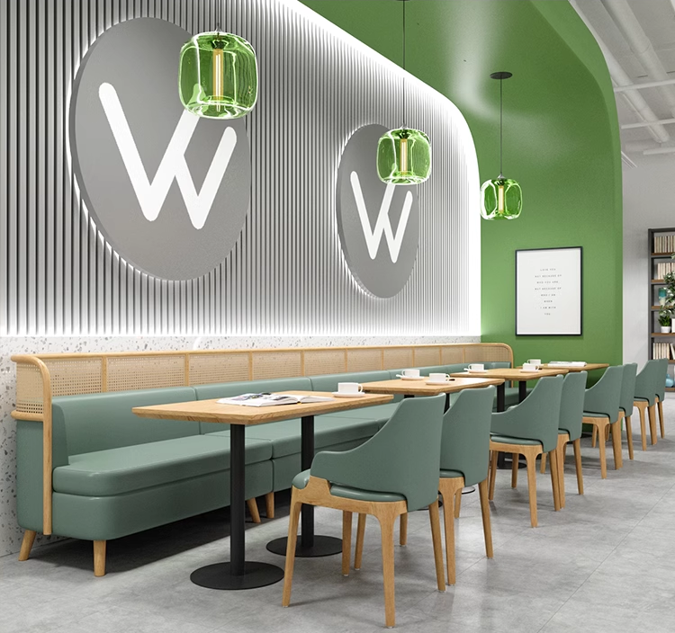 Green chairs paired with wooden tables in a sleek cafe interior, providing a stylish and functional seating arrangement.