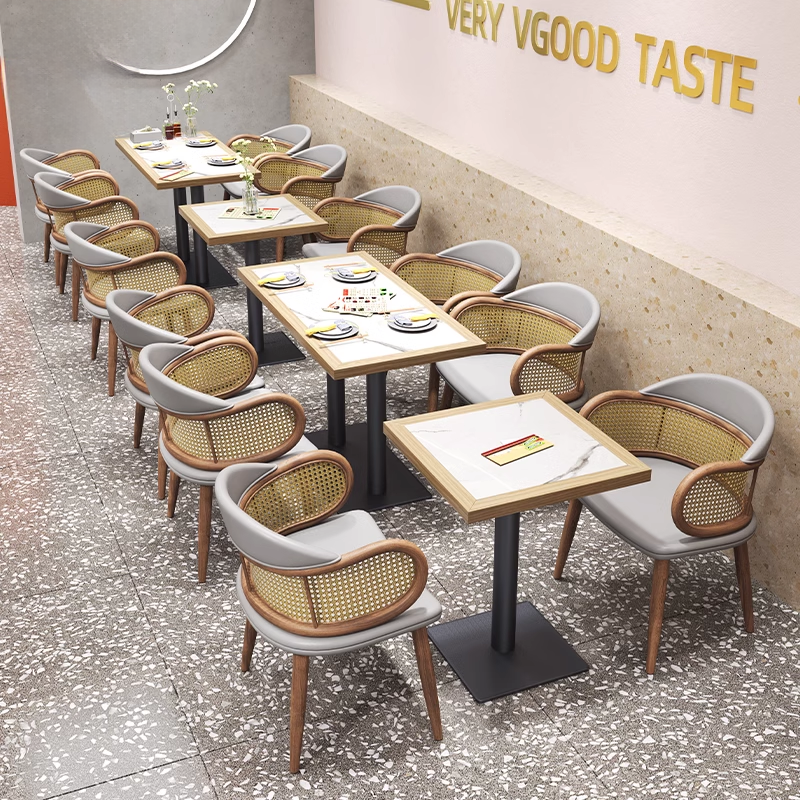 Modern cane back restaurant chair with grey leather seat and natural wood legs, ergonomic design for dining areas