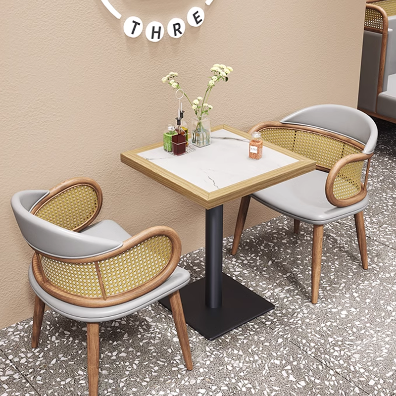 Modern cane back restaurant chairs with grey upholstery and wooden legs, stylish seating for dining spaces