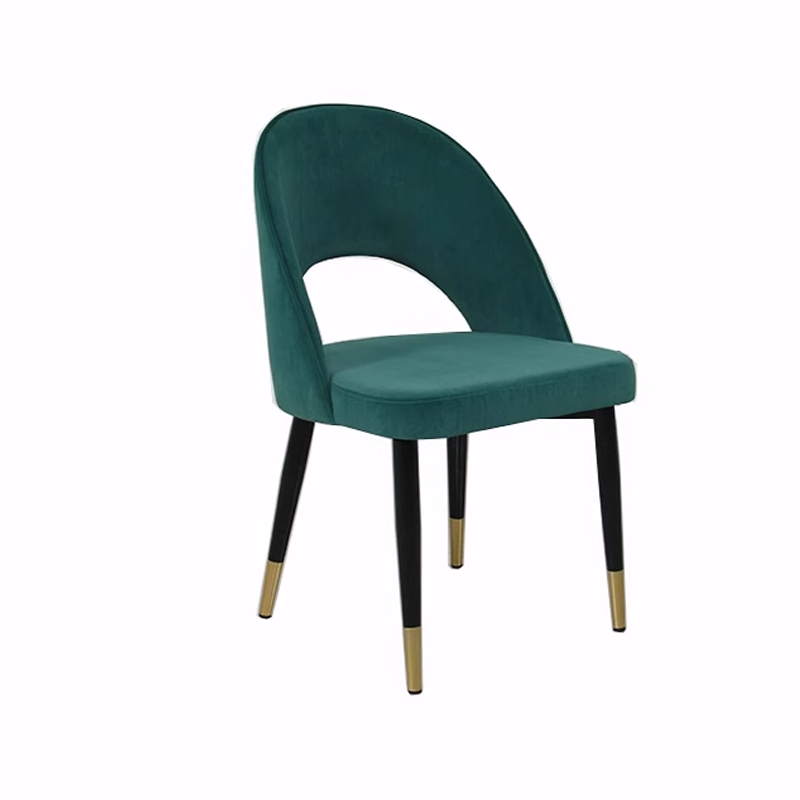 Elegant green velvet dining chair with a curved backrest, black legs, and gold accents.