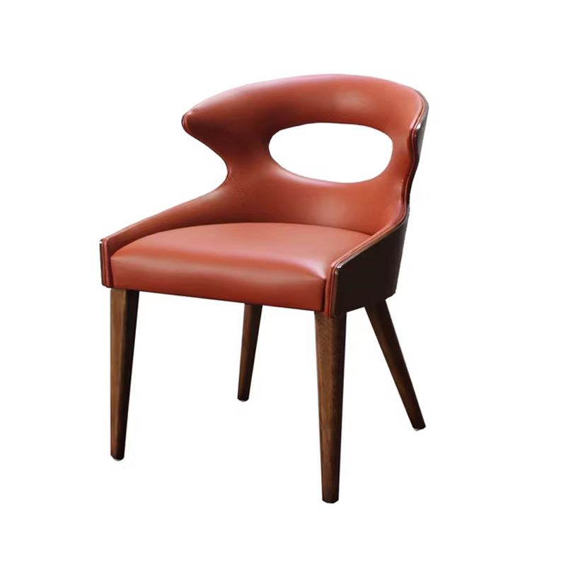 Contemporary orange leather chair with wooden legs and a unique cut-out backrest, perfect for modern dining or office spaces.