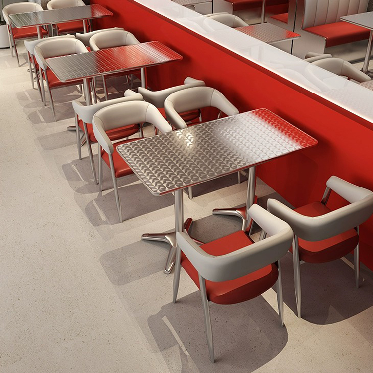 Modern dining space with red and white booth seating and steel dining tables.