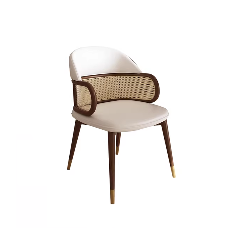 Modern woven cane-back dining chair with white faux leather seat and wooden legs, designed for contemporary dining spaces.