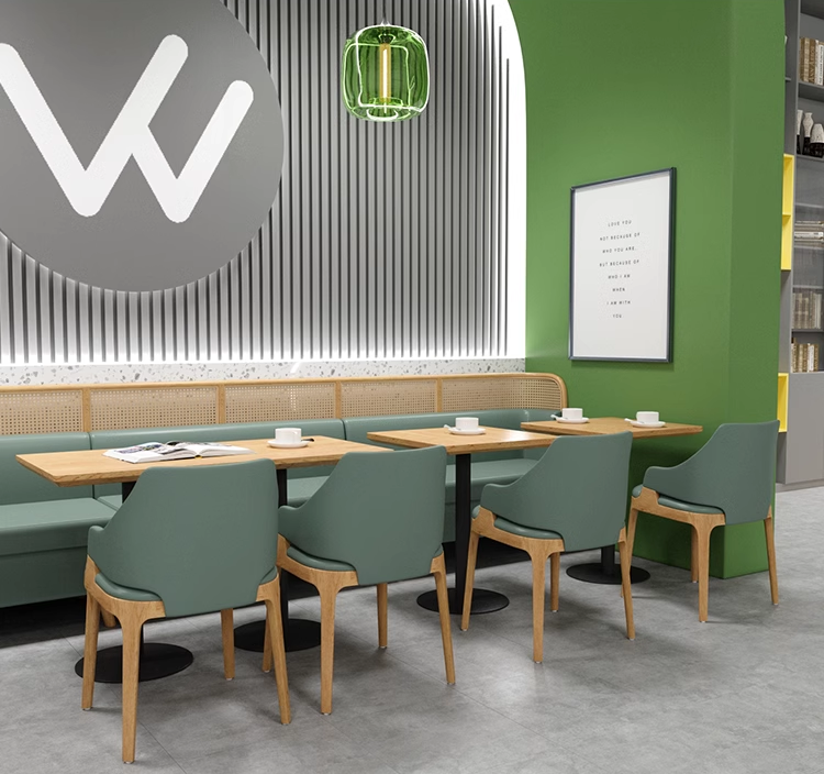 Contemporary cafe seating with green chairs and wooden tables, offering a chic and comfortable dining experience.