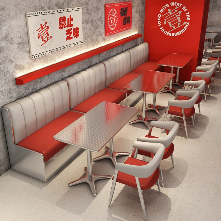 Diner-style seating arrangement featuring red and white upholstered booth, modern metallic chairs, and polished steel tables.