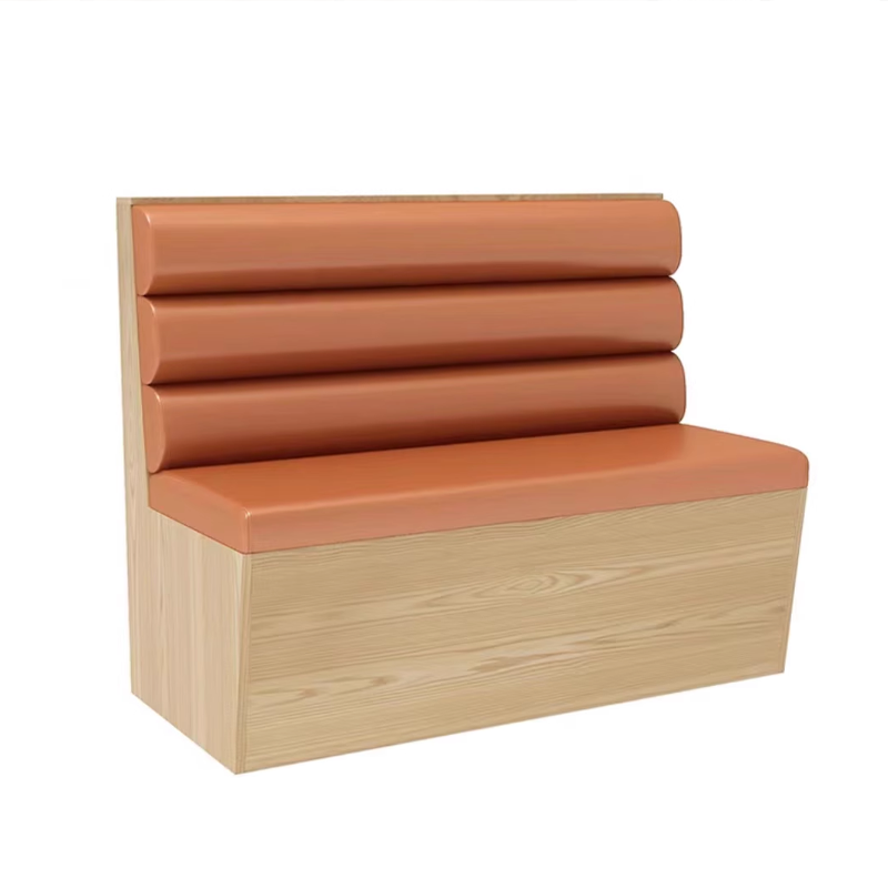 Restaurant booth seat with orange cushion and wooden base