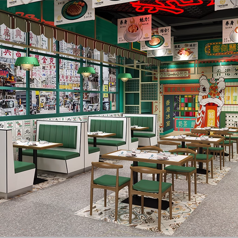 Restaurant interior featuring green booth seating, wooden tables, and a vibrant, eclectic decor, designed for a cozy dining experience.