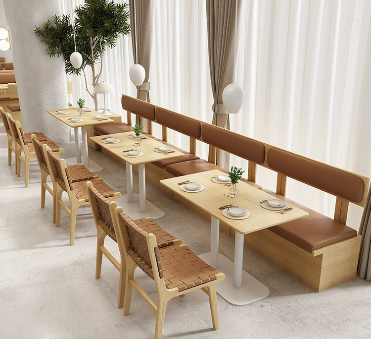 Restaurant seating arrangement with light wood tables and woven-back wooden chairs, perfect for minimalist dining spaces.