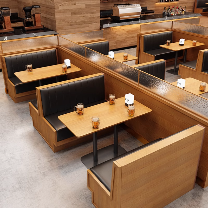 Wooden booth seating with black backrest, VIP seating area in modern cafe.