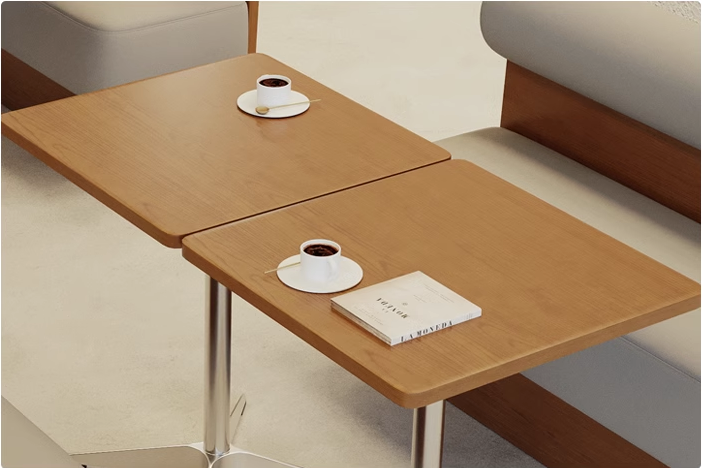 Close-up of a wooden coffee shop table with two cups of coffee and a book placed on it, creating a cozy atmosphere.