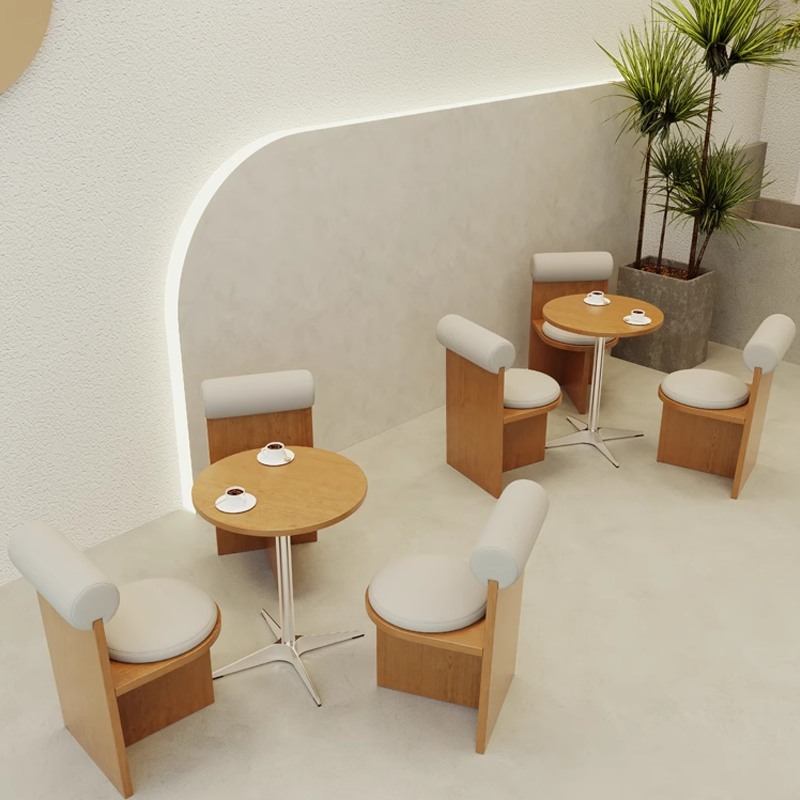 Another view of the coffee shop interior with round and square tables, featuring a relaxed ambiance for customers to enjoy.