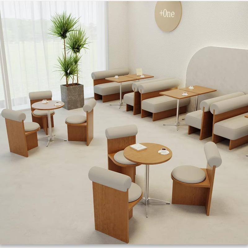 Coffee shop interior with a modern wooden table and seating setup, featuring circular and rectangular tables with matching chairs.