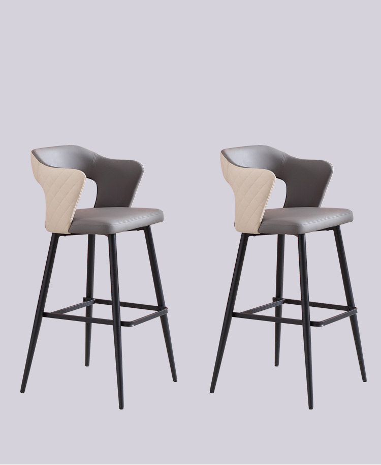 Two-tone customizable leather barstools with quilted backrests, featuring black metal frames and footrests.