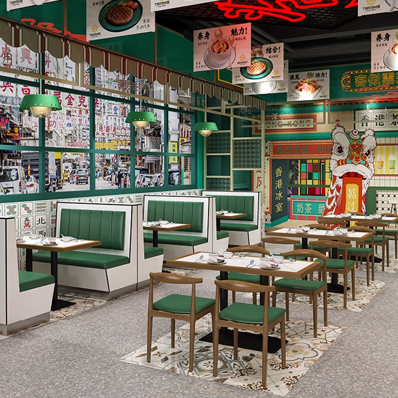 Dining area featuring green leather booth seating and rock slab dining tables with black metal bases.