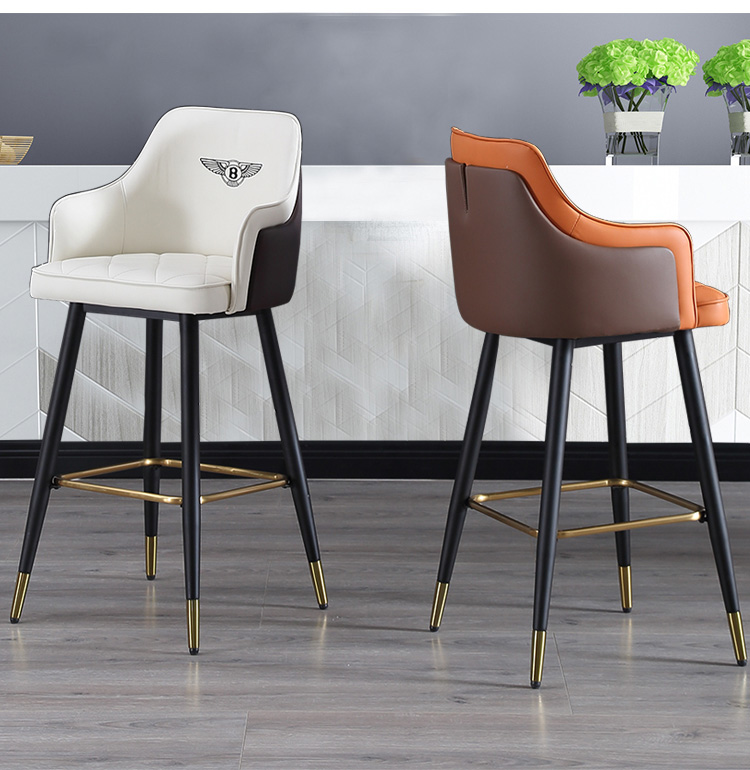 High-quality white and orange leather bar stool with black metal legs and gold footrests, ideal for modern spaces.