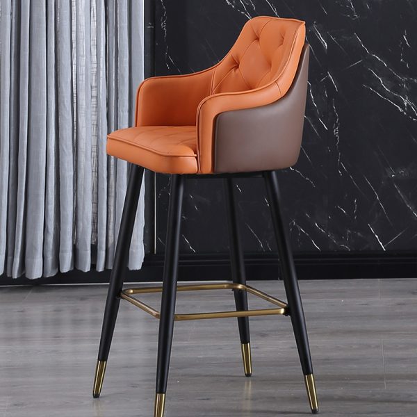 Modern two-tone bar stool with ergonomic armrests, comfortable padded seat, and metal legs in black with gold accents.