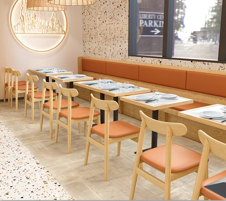 A rectangular marble-topped restaurant table with oak wood edging, supported by two black pyramid-shaped metal legs.