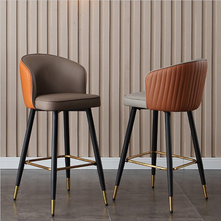 et of three modern bar stools in brown, grey, and orange with gold legs, designed for contemporary spaces.