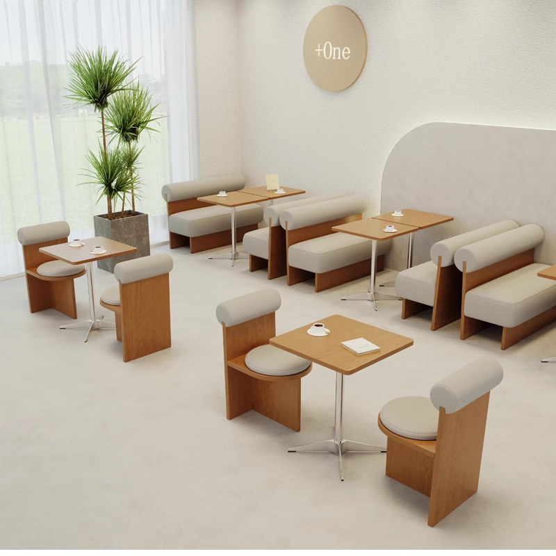 A stylish cafe interior featuring tables with cushioned seats and contemporary decor elements.