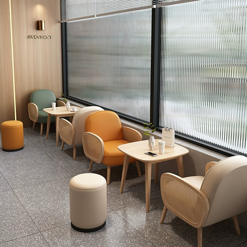 A cozy modern café featuring wooden chairs with woven backs and light wood tables, creating a comfortable environment.