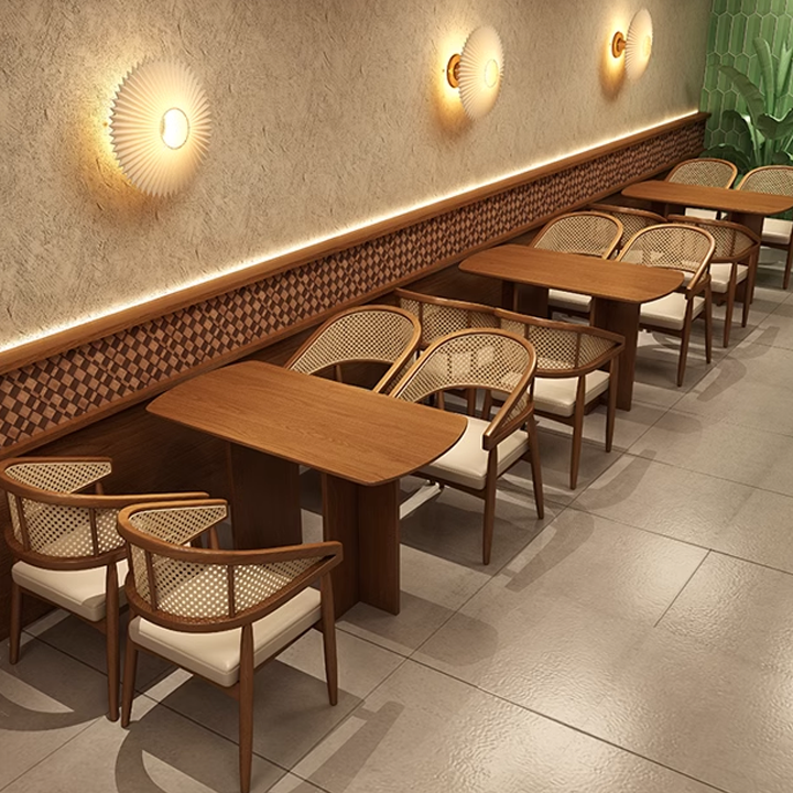 Contemporary dining setting with wooden cane chairs and ambient lighting. 