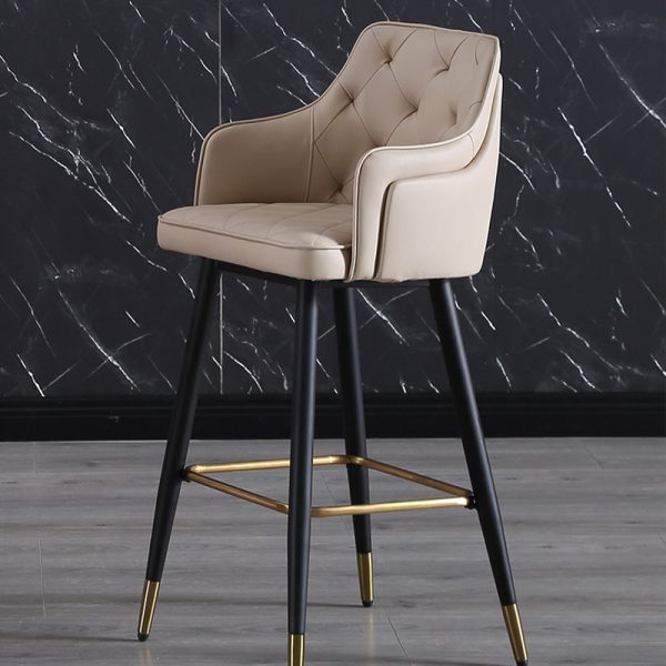 Bar stool with orange PU leather seat, black metal frame, and gold footrest, featuring ergonomic back support and modern design.